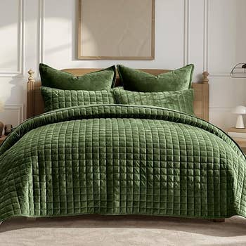 Luxurious quilted bedding acceptable with plush pillows connected a woody furniture frame, creating a cozy and inviting chamber atmosphere