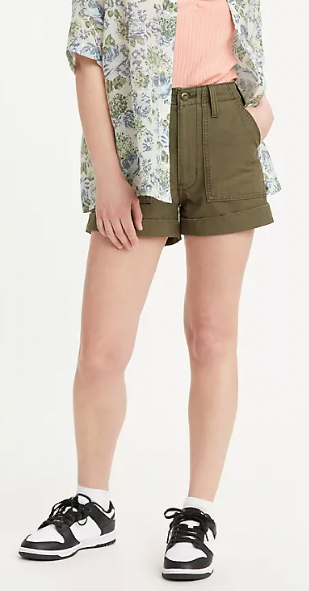 Model in high waisted green shorts with pockets