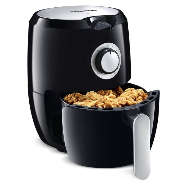 An air fryer with chicken in the compartment
