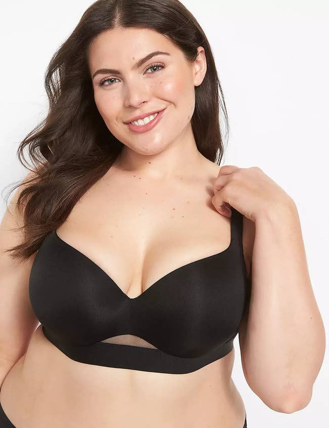 A exemplary  wears a supportive achromatic  bra with a mesh detail, smiling astatine  the camera, for a manner  buying  article