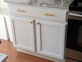 white cabinet with brass pulls