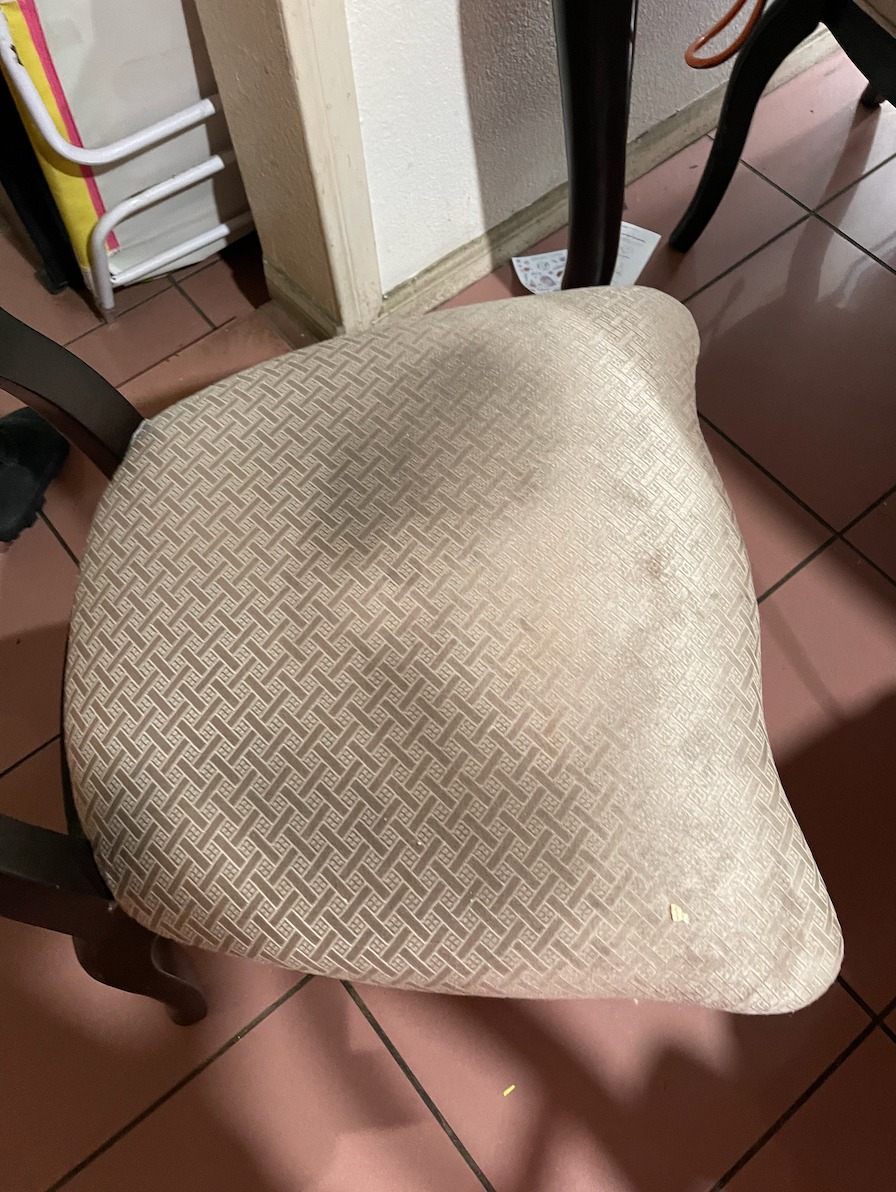 reviewer before showing a stained dining room chair seat