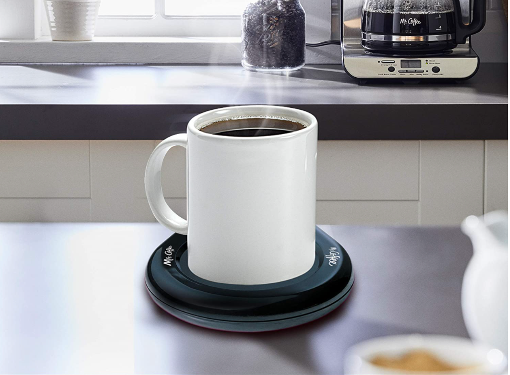 mug of coffee on the black warmer pad