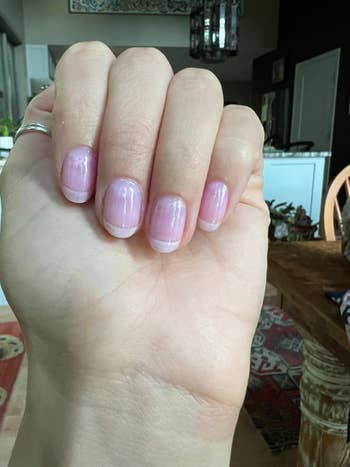 Close-up of a hand showing polished, natural-looking manicured nails