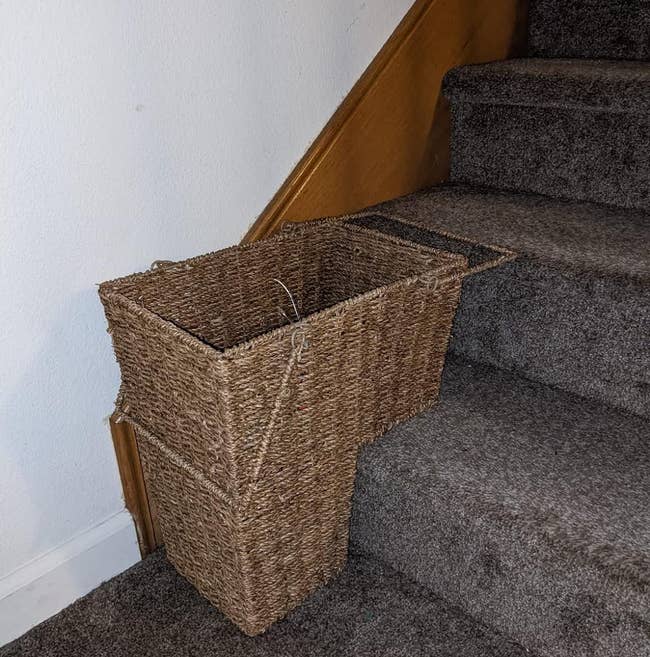 a reviewer's basket on their carpeted stairs 