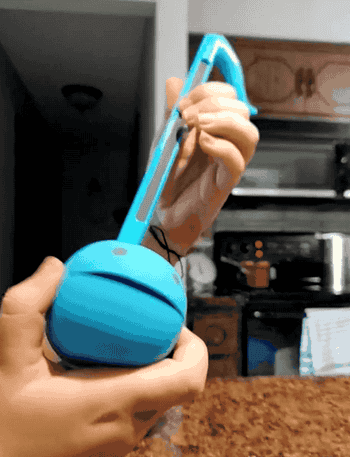 A reviewer playing the otamatone
