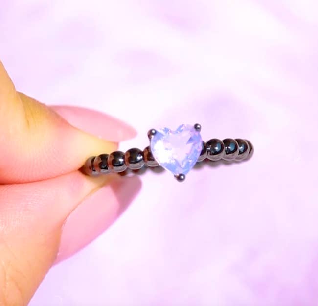  heart-shaped lavender gemstone ring on black gold bead effect band