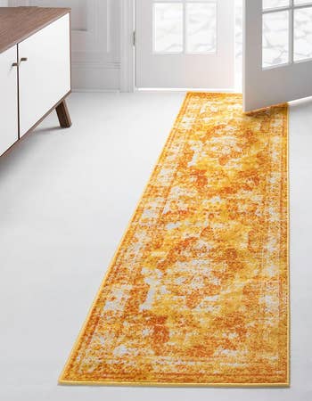 Long, patterned runner rug in a home interior setting, suitable for hallway or entryway decor