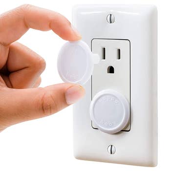 model inserting the babyproof plug into outlet