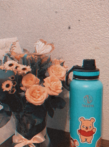 reviewer water bottle covered in stickers