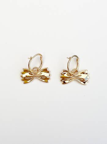a close up of the gold earrings