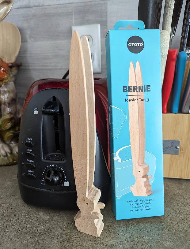 reviewer's rabbit tongs standing on kitchen counter beside packaging