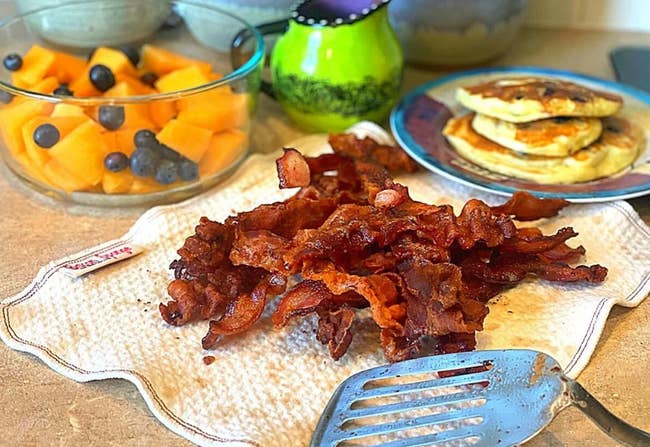 Pile of bacon sitting on the quilted cloth