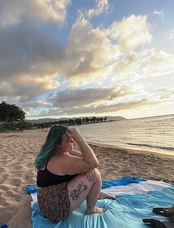 reviewer sitting on the beach blanket