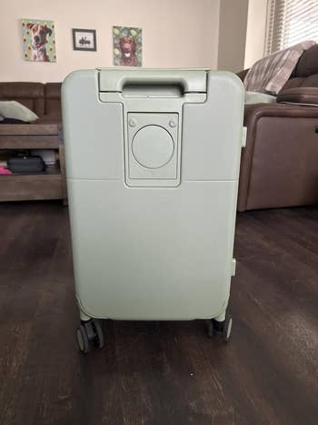 A sleek, modern   wheeled suitcase with a minimalist plan  displayed successful  a stylish surviving  country   setting