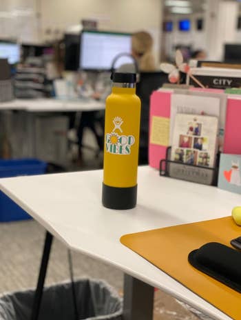 reviewer photo of the water bottle on their desk in yellow
