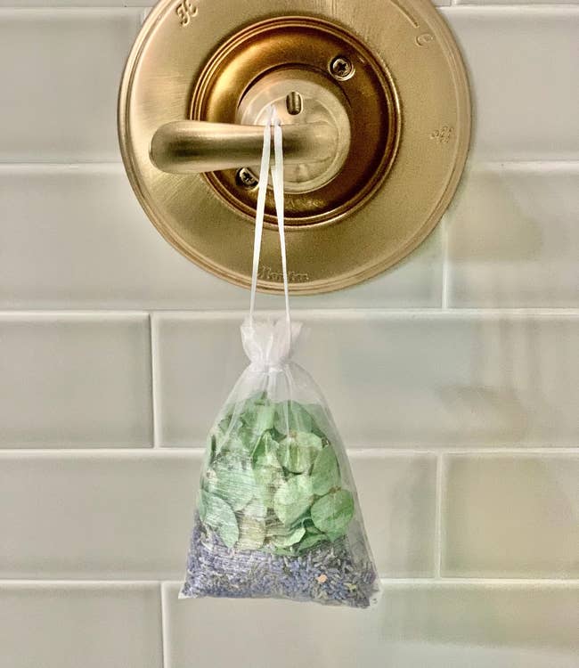 the eucalyptus and lavender pouch hanging in a shower