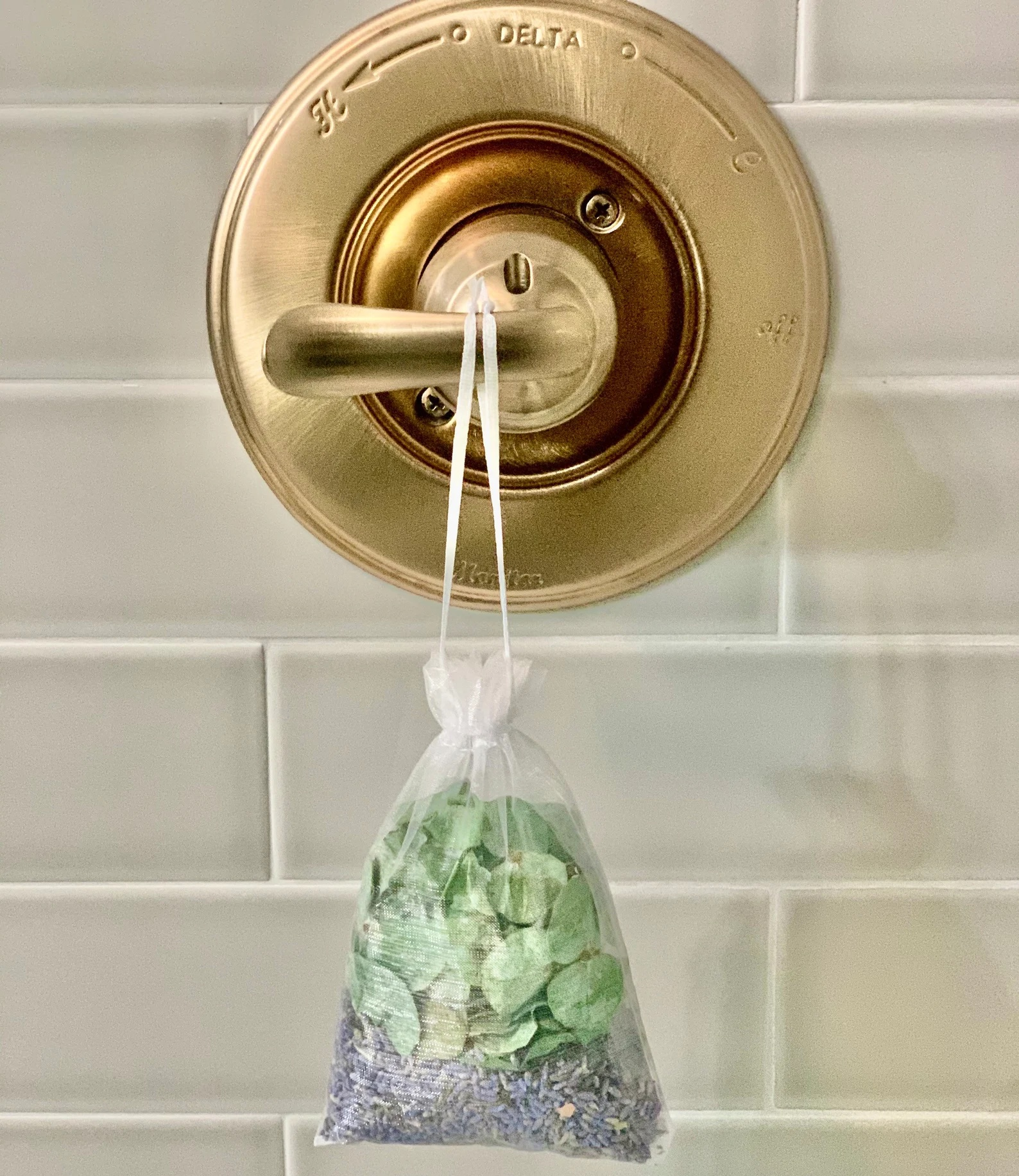 the eucalyptus and lavender pouch hanging in a shower