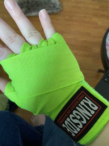 reviewer with lime green wraps on hand