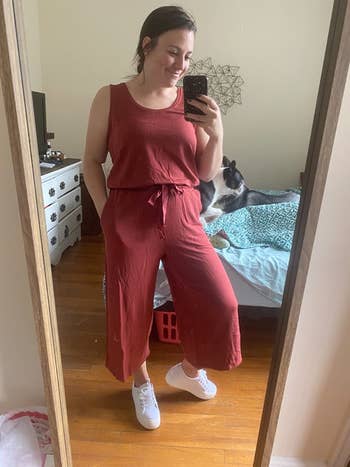 reviewer in same style jumpsuit in a red tone