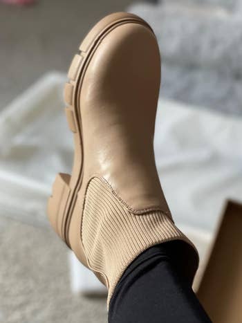 Close-up of a person wearing a new boot with elastic side panels