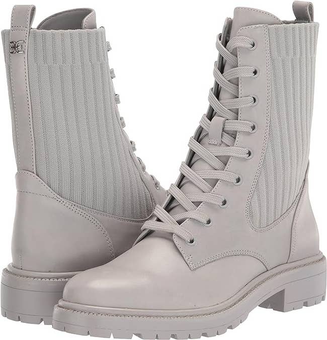 Pair of white lace-up boots with ribbed side panels