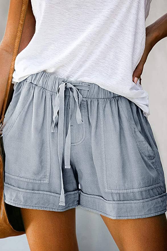 Model in drawstring pale blue shorts with pockets 