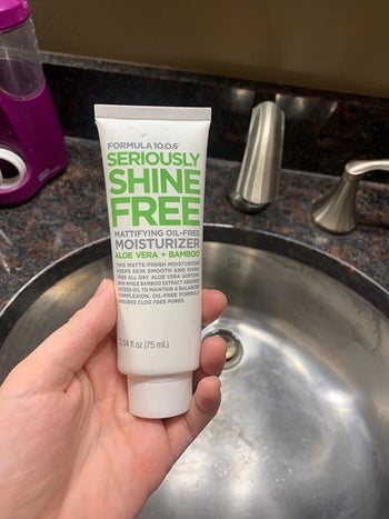 image of reviewer holding up the moisturizer
