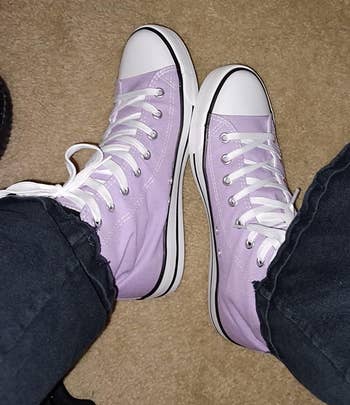 a reviewer wearing the sneakers in light purple 