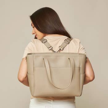 A model showcasing how the tote can be worn as a backpack