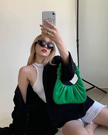 model with green ruched bag with scrunched handle