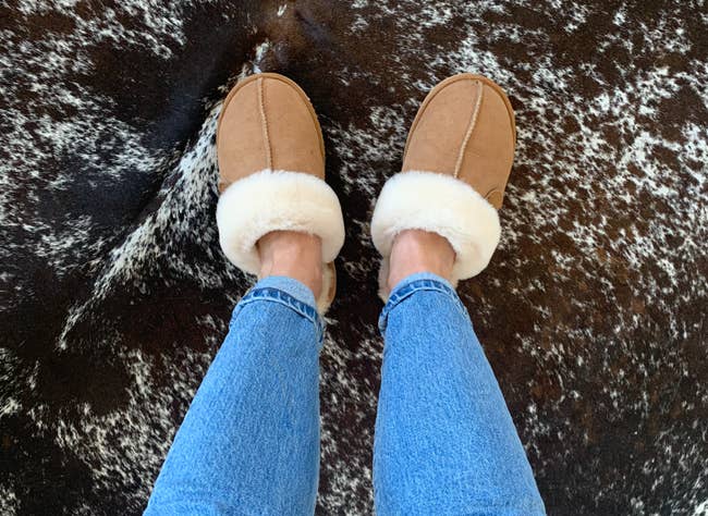 a reviewer wearing the slippers in chestnut