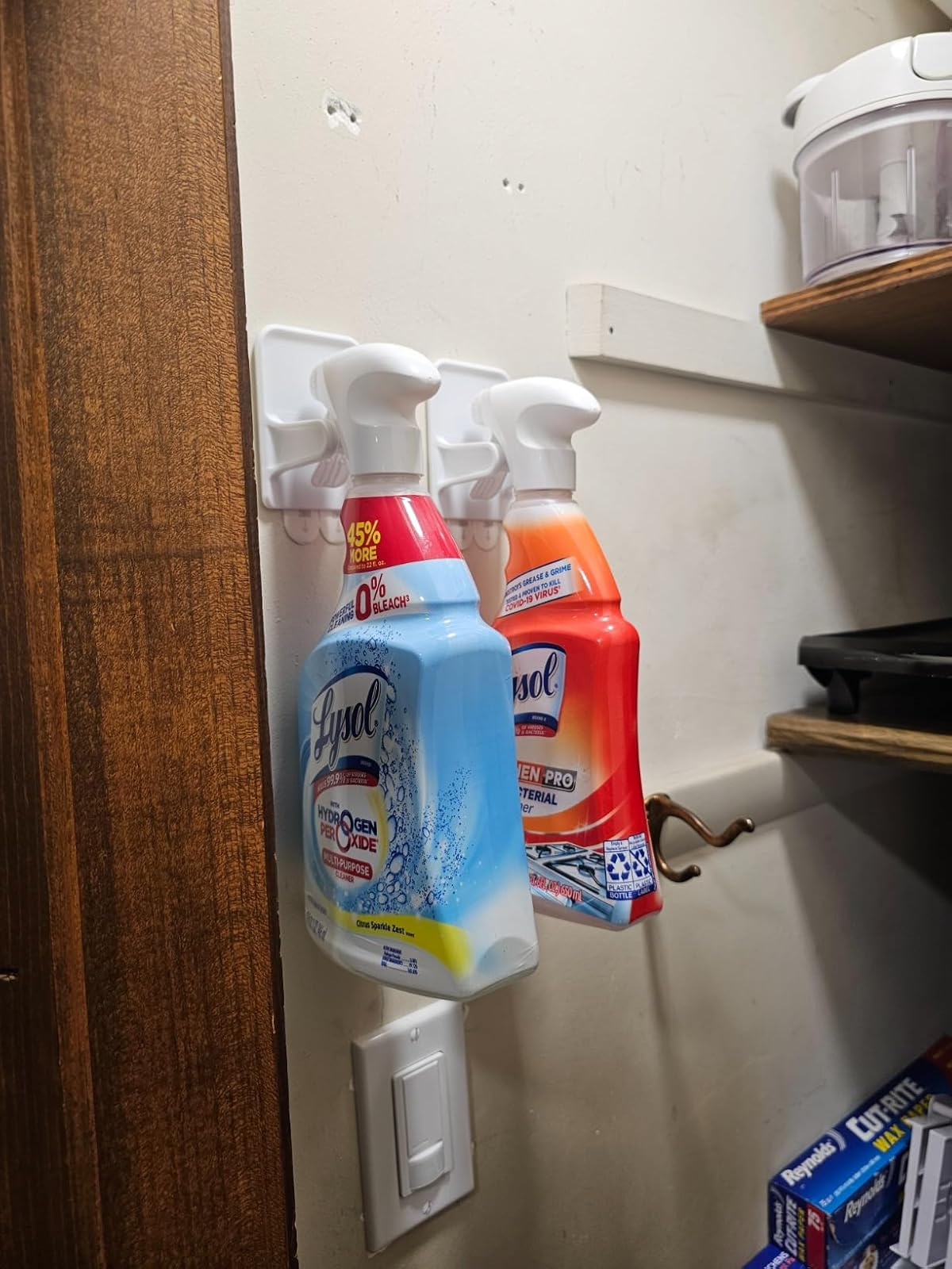 Spray bottles of cleaning products connected  a partition  equine   successful  a retention  country  with shelves and supplies nearby