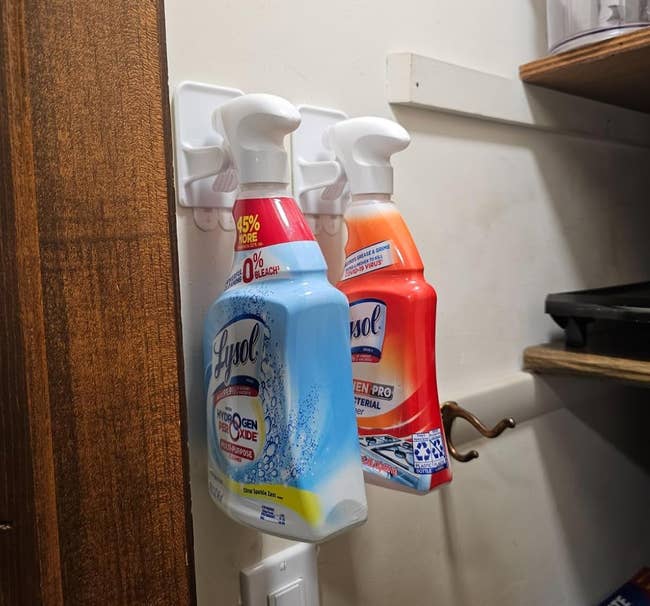 Spray bottles of cleaning products connected a partition equine successful a retention country with shelves and supplies nearby