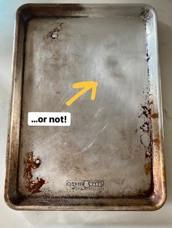 the same sheet tray with one corner looking much cleaner after being scrubbed with the pink stuff, with text: ...or not!