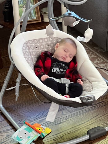 a baby in the graco swing