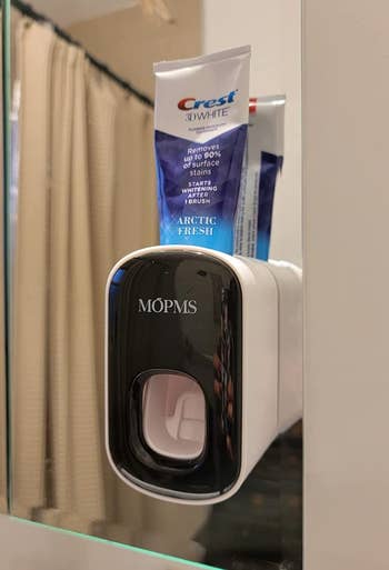 reviewer photo of the black dispenser mounted to a bathroom mirror
