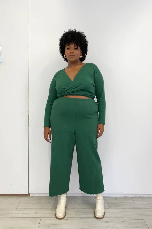 a plus size model wearing the eucalyptus green knit pants