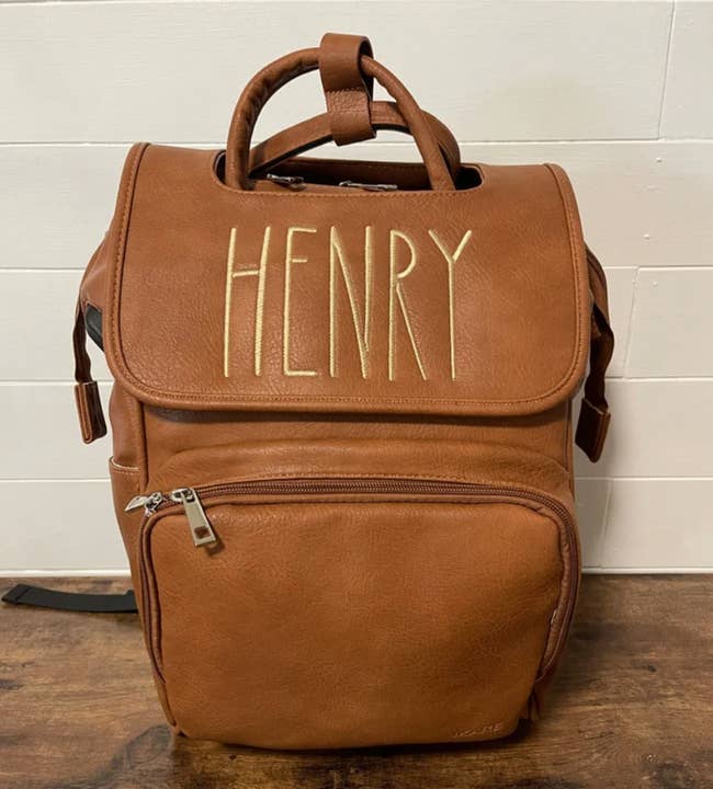 Image of brown backpack with the name Henry on it