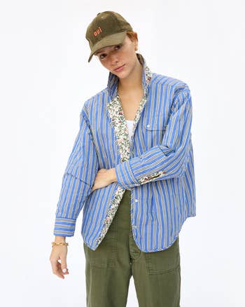 model wearing jacket with blue shirt stripe print facing out and floral lining showing