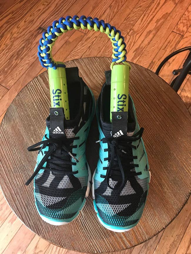 The sticks attached by a rope handle inside a pair of sneakers