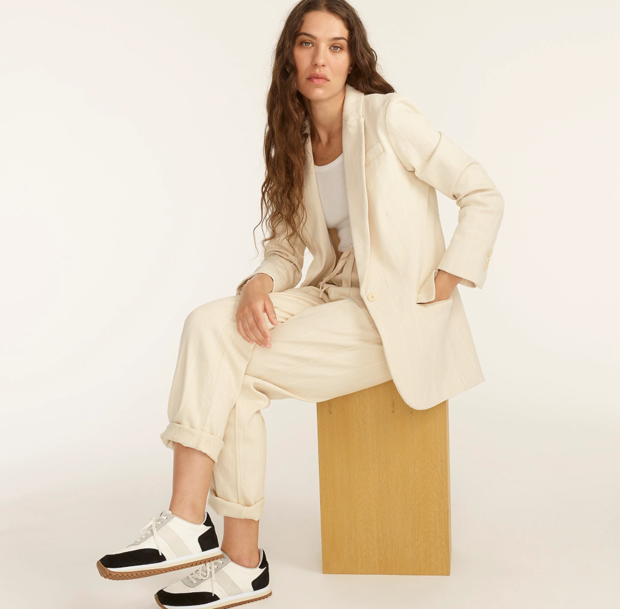 model wearing the cream and white striped blazer
