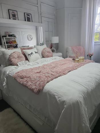 Reviewer's pink blanket on white bedding