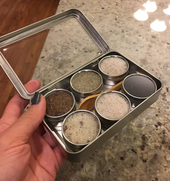 A small tin of six containers of infused salt 