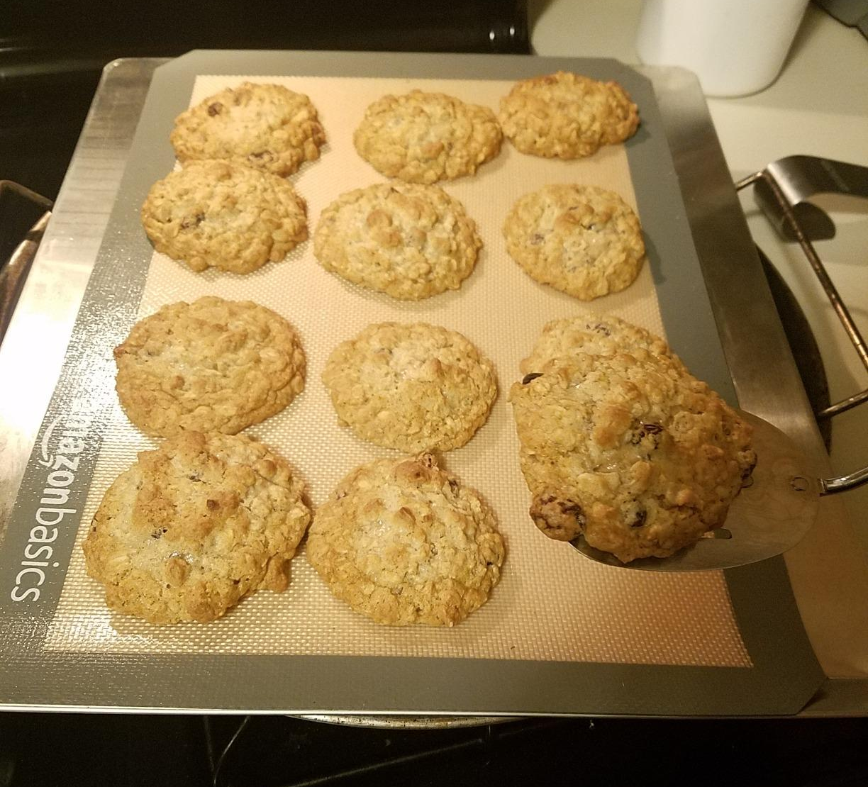 a reviewer photo of a silicone mat on a baking sheet with cookies on it 