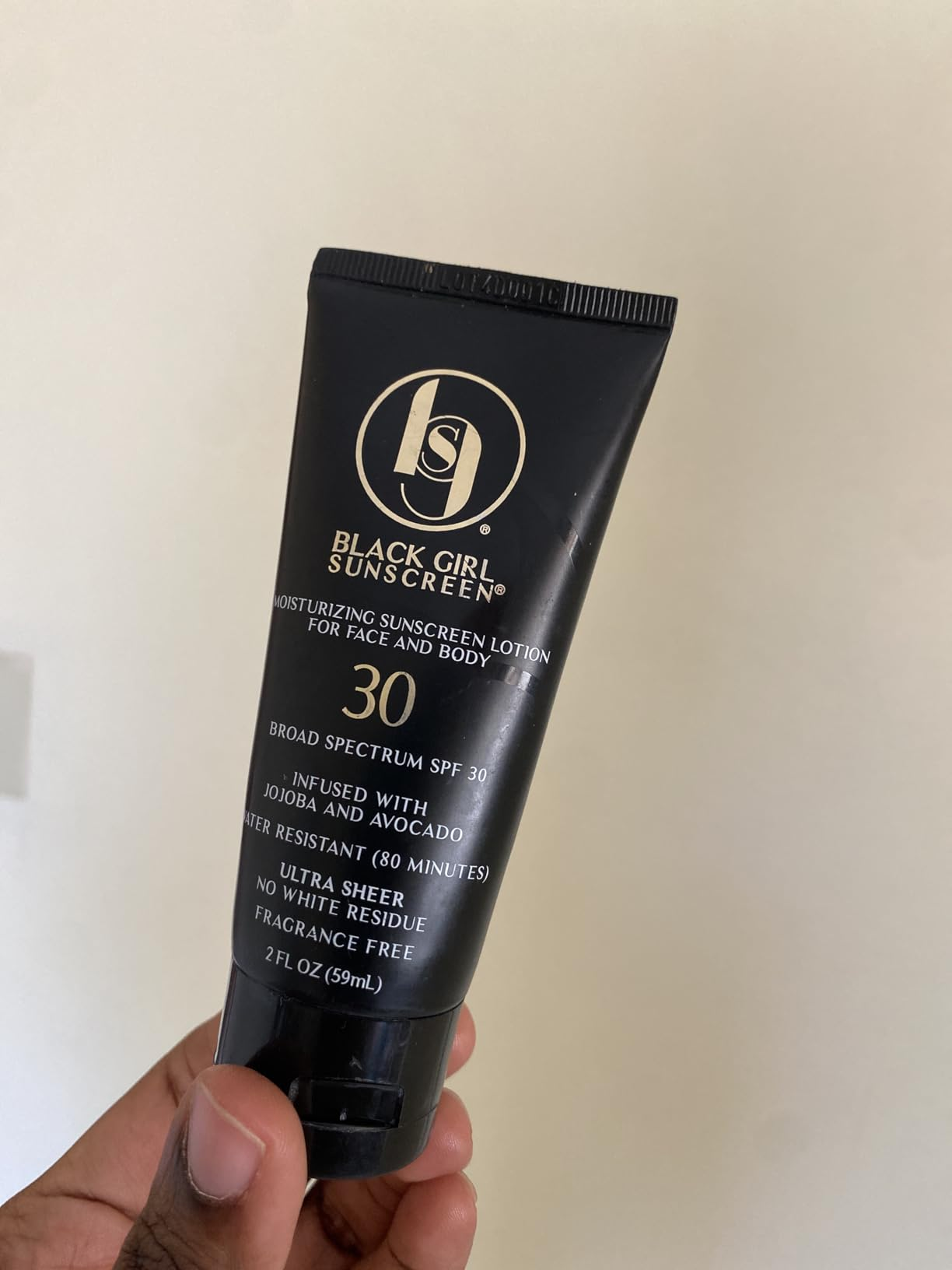 A idiosyncratic   holding the sunscreen