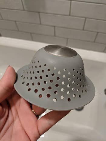 Reviewer holding hair catcher