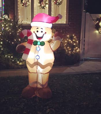 reviewer photo of the lit up gingerbread person in their yard at night