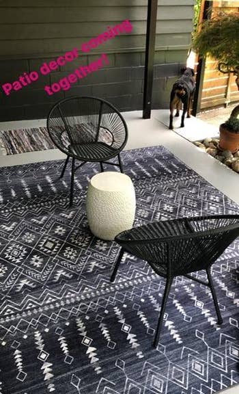 a blue moroccan style rug set up under patio furniture
