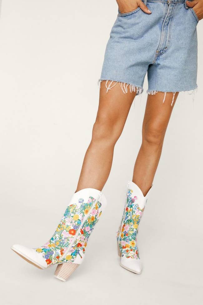 model in white and colorful floral cowboy boots